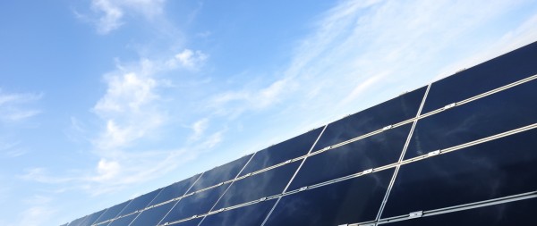 Solar panel under a sunny yet cloudy sky.