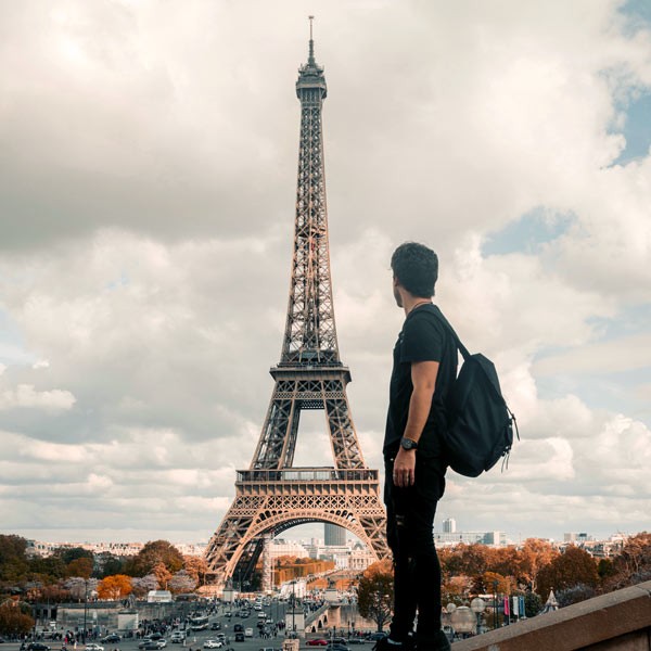 Man looking at Eiffel Tower, Paris, France