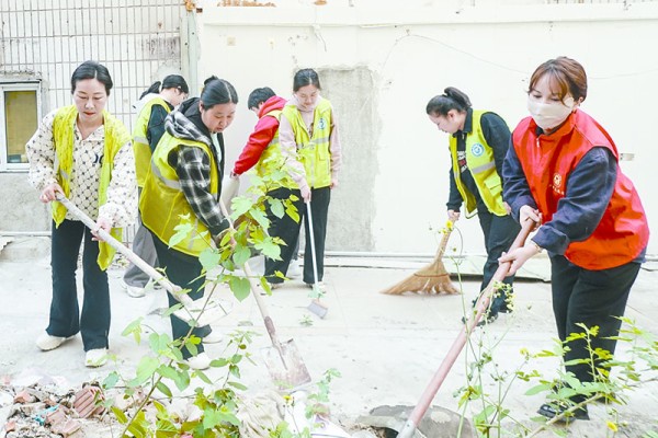 图为沙塘路街道沙塘社区党委对一处违建拆除后形成的“卫生死角”进行突击大清理 。胡智慧 王素英 摄