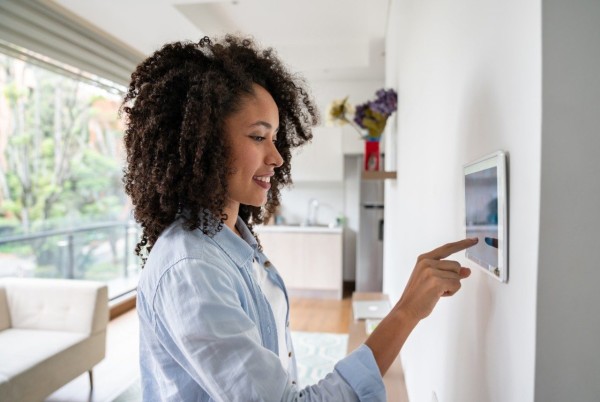 woman-using-smart-home-touchpad-getty-1208577991
