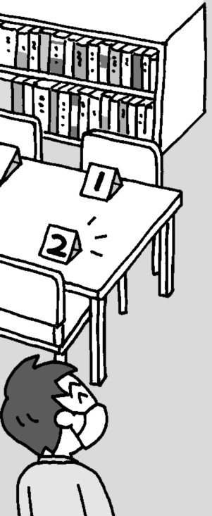 番号が付いた座席を見る教師