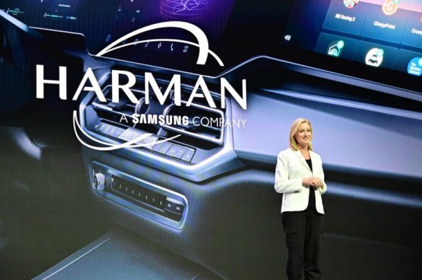 A person standing in front of a large screen Description automatically generated