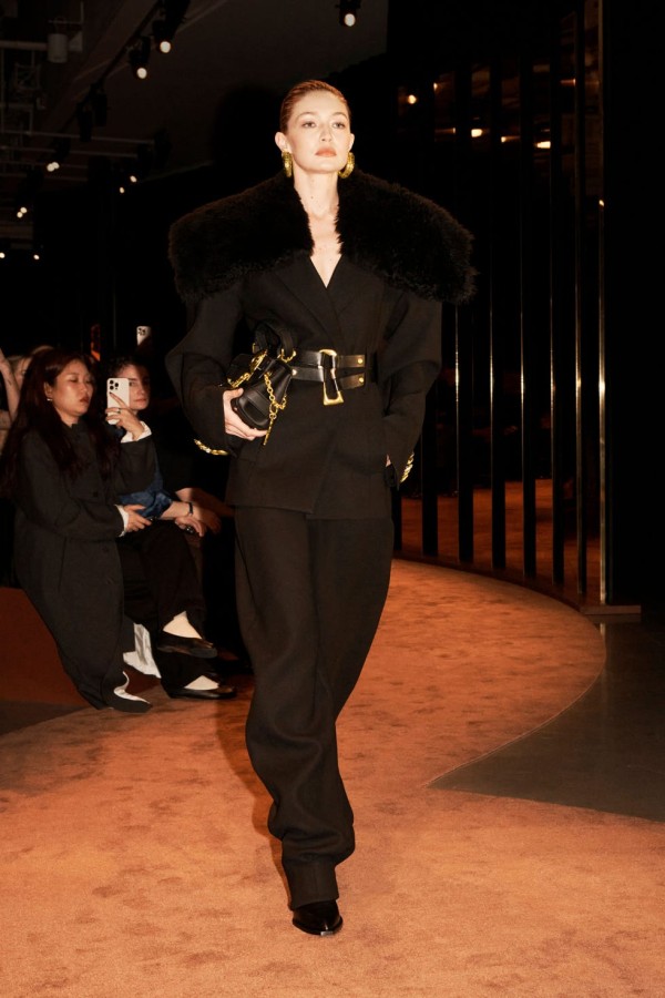 model walking the runway in ensemble with bold fashion elements