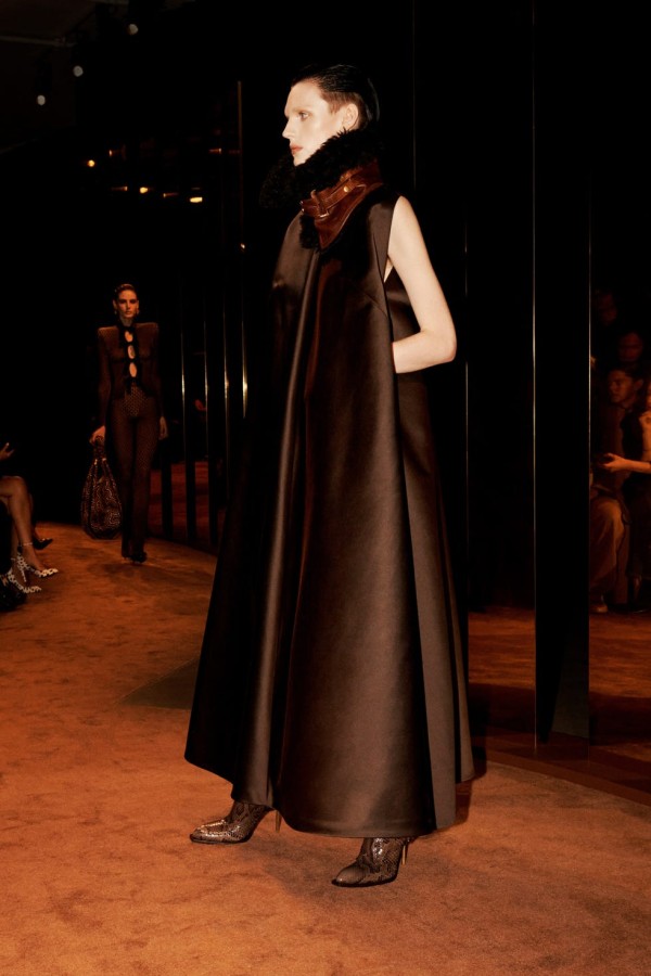 fashion runway showcasing a model in an elegant dark ensemble