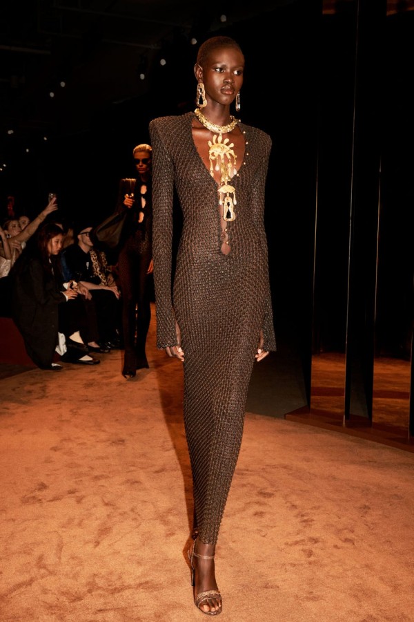 fashion model showcasing a distinctive dress on a runway