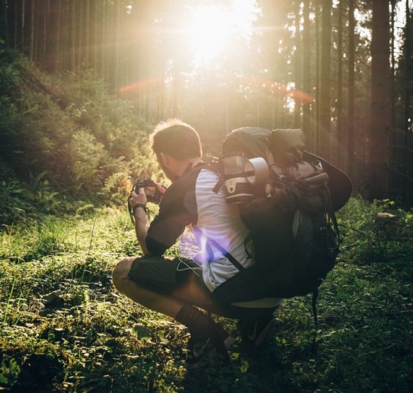 hot to pack a backpack - man with backpack in forest