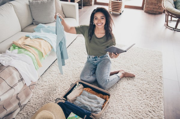 Woman Packing Suitcase for Solo Travel Trip - Solo Travel Packing List Female