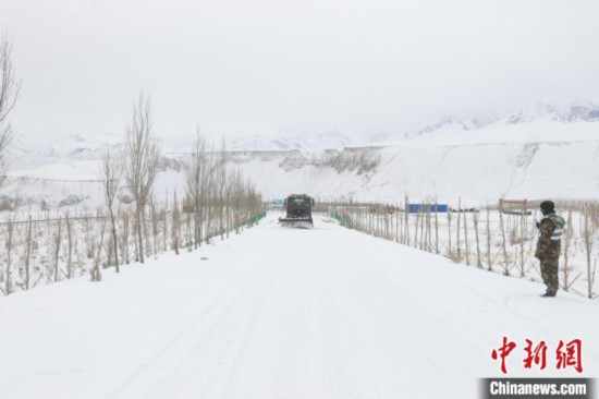 图为救援官兵正在紧急清理路面积雪。　董尼么太 摄