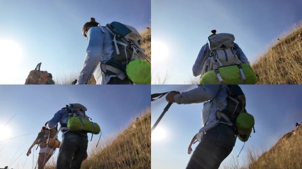 冒险旅行生活方式：一对快乐的背包客在山中互相帮助徒步旅行。