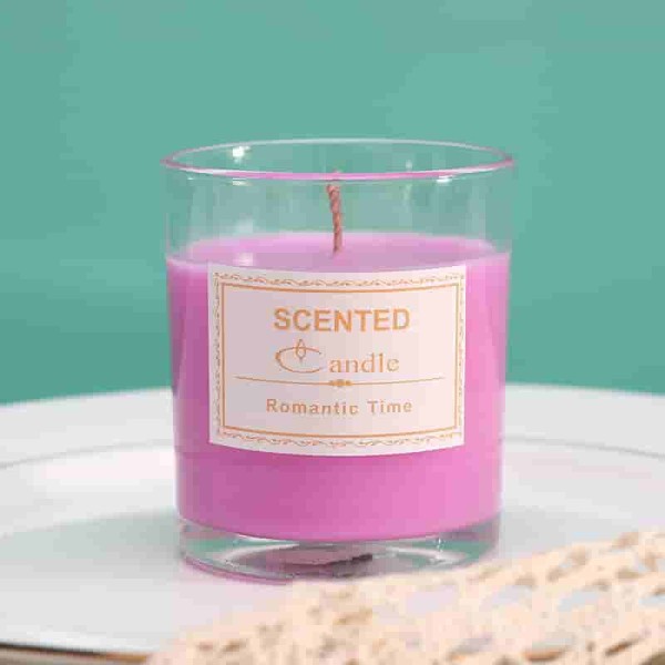 crystal clear glass candle jar with pink wax in it