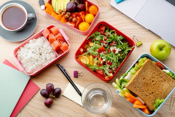 top view shot with healthy lunch dishes variety salad with grains, salmon and rice, sandwich and fruit snacks daily office or school lunch concept
