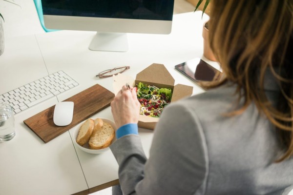 woman eating salad for lunch at her desk