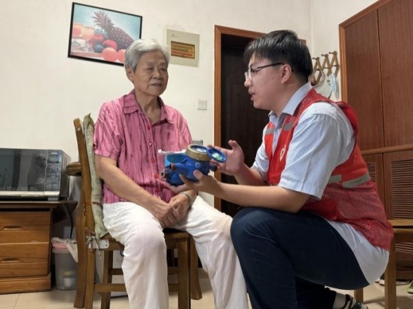 志愿者为独居老人讲解物联网智能水表工作原理。合肥水务集团供图