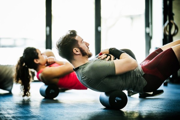 gym goers performing floor exercises together