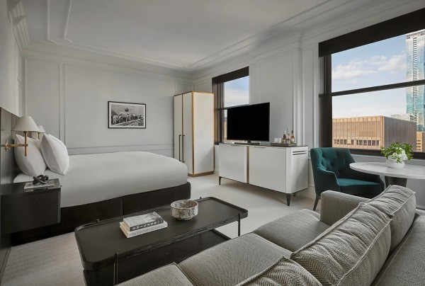 Guestroom with green chair and soft seating