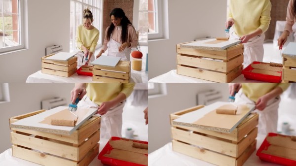 女性在明亮的家庭空间中通过粉刷墙壁进行创意家居改造。