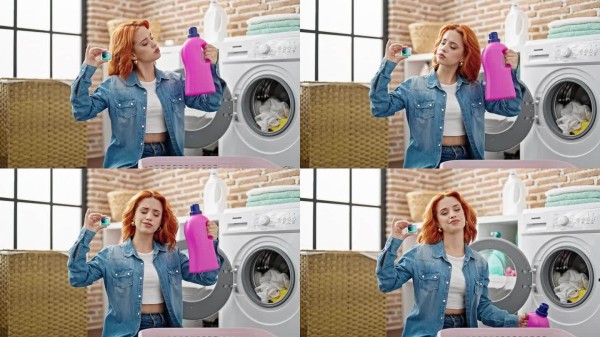 年轻的红发女子在洗衣房洗衣服,选择洗涤剂