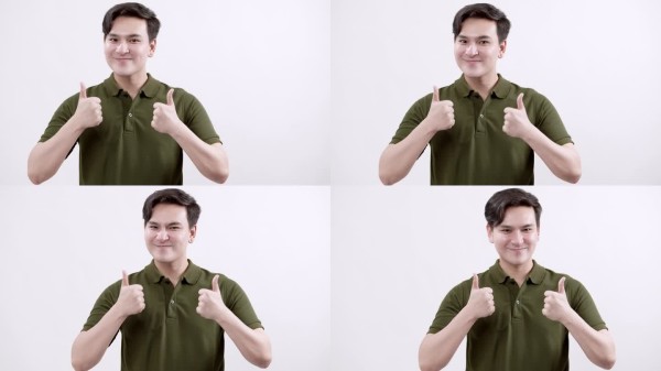 一个年轻人分享了一个快乐的时刻,竖起大拇指,传递积极和自信的情绪。