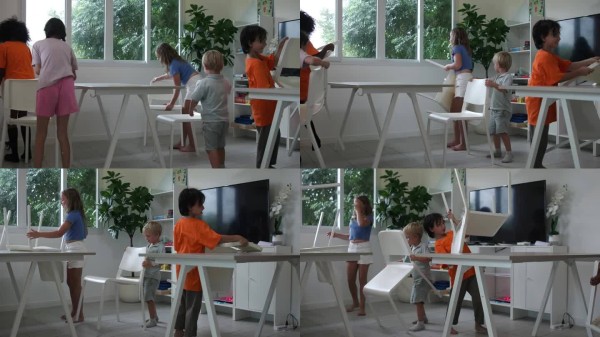孩子们在国际学校的教室里清理和整理房间，把椅子倒扣在桌子上。学习生活方式。