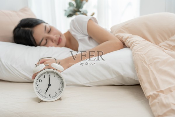 简单的生活方式,亚裔女性在周末早晨睡得很好,在家舒适的卧室窗边休息,享受放松,快乐的懒散的一天,享受工作与生活的平衡照片摄影图片