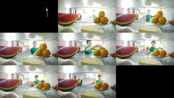 第一人称视角：从冰箱内部拍摄，一个男孩打开冰箱门取出食物。